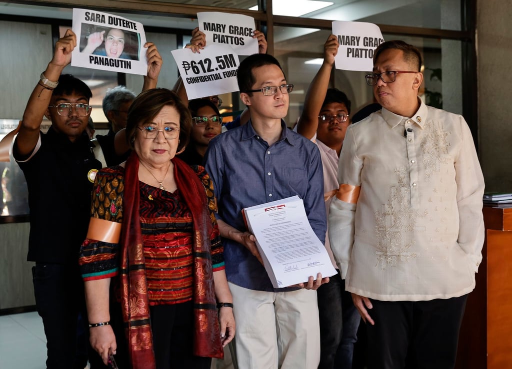 Philippine legislators Leila de Lima (front, left) and Perci Cendana (front, right) after filing an impeachment complaint against Vice-President Sara Duterte at the House of Representatives on Monday. Photo: EPA
