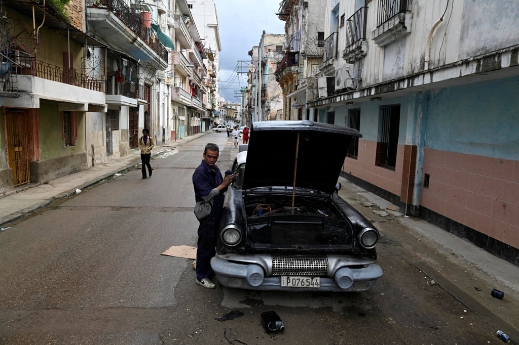 A mechanic fixes a car on the street in Havana, as Cubans hunker into survival mode. Photo: Reuters