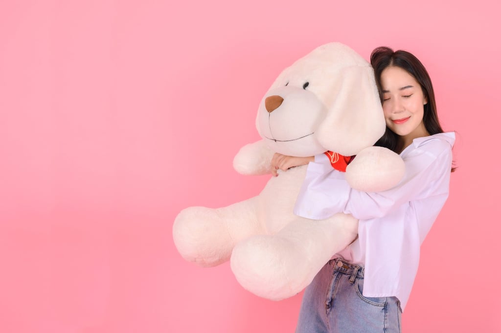 A young woman hugs a big teddy bear. Some doll mummies say their “children” even begin to smell like them, such is the level of their attachment to the toys. Photo: Getty Images