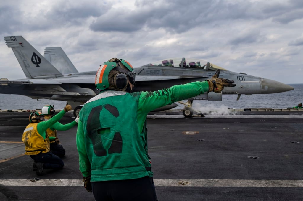 An F/A-18F jet prepares to launch from the USS Abraham Lincoln in the Arabian Sea. Photo: US Navy via EPA