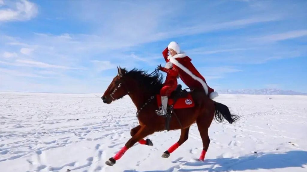 He Jiaolong rides her horse dressed in a festive outfit across a snowy expanse in Xinjiang. Photo: nfnews
