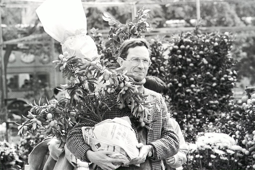 Solicitor Jeremy Mathews, who would become the attorney general of Hong Kong the following year, with a kumquat tree at the Victoria Park flower market in 1987. Photo: SCMP Archives