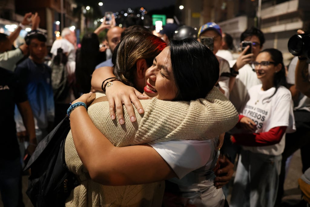 Maria Oropeza is embraced outside the Helicoide detention centre after she was released. Photo: Reuters Maria Oropeza is embraced outside the Helicoide detention centre after she was released. Photo: Reuters