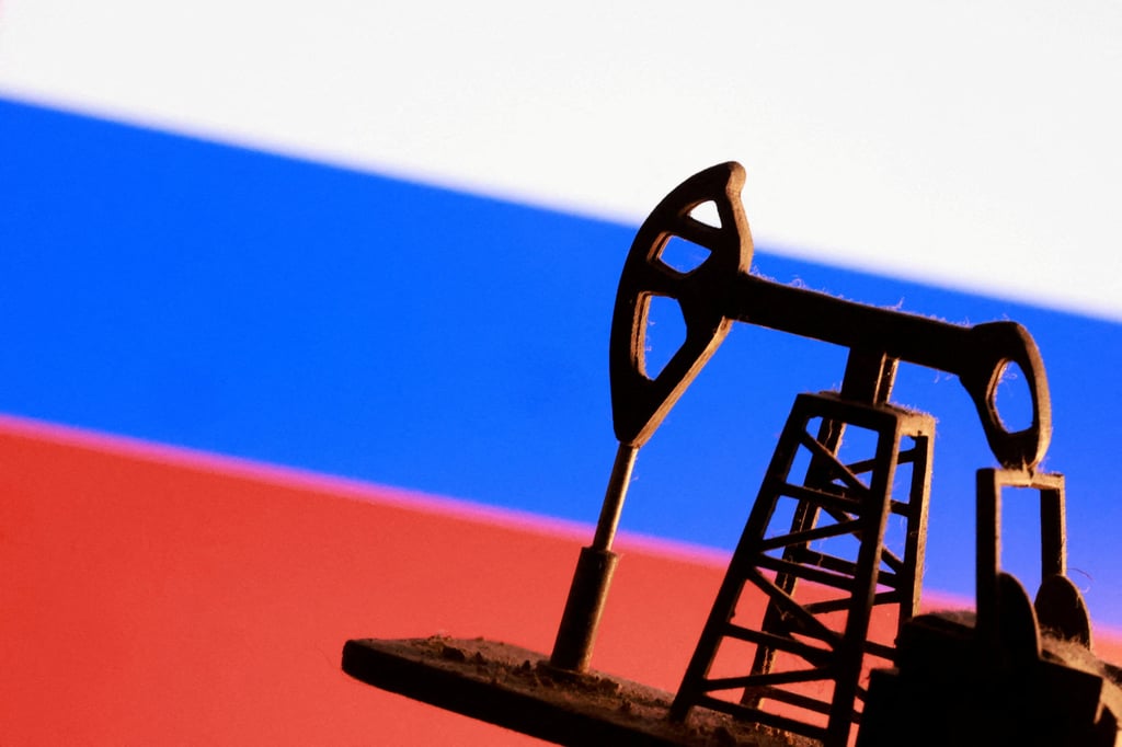 A model of an oil pump in front of a Russian flag. India imported more than US$60 billion worth of oil and petroleum products last year. Photo: Reuters
