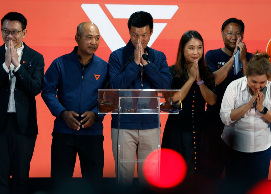 People’s Party leader Natthaphong Ruengpanyawut (centre) and key members greet after a press conference to concede the general election on Sunday. Photo: EPA