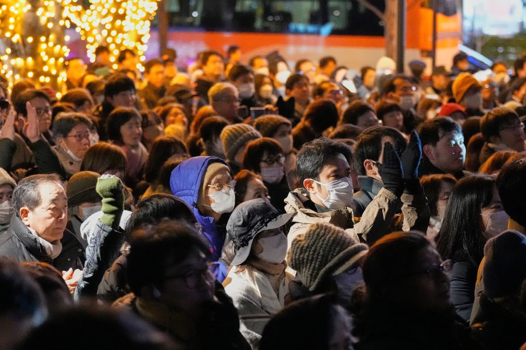 Supporters of the Centrist Reform Alliance listen to a speech at a campaign rally on Saturday, the eve of Japan’s election. Photo: AP