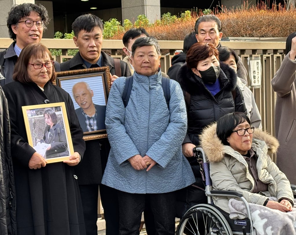 Plaintiffs, their lawyers and supporters gather outside the Tokyo District Court after it ordered North Korea to pay damages for luring Japanese to the North with false promises on January 26. Photo: AP Plaintiffs, their lawyers and supporters gather outside the Tokyo District Court after it ordered North Korea to pay damages for luring Japanese to the North with false promises on January 26. Photo: AP