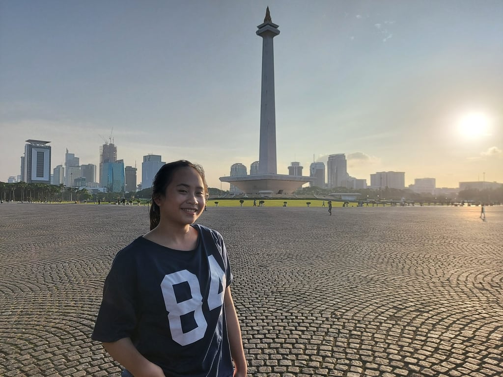Fitri Sartika Rama, standing in front of Monas, Indonesia’s National Monument, calls Jakarta a “young person’s city” but says she would not like to live there long term. Photo: Aisyah Llewellyn