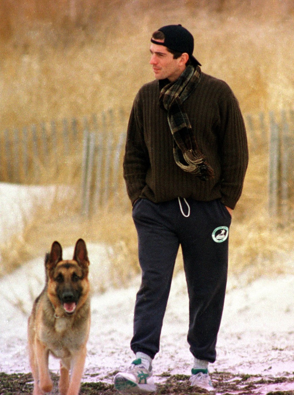 JFK Jr walking his dog on the beach in the US state of Massachusetts, in early 1995. Photo: Getty Images