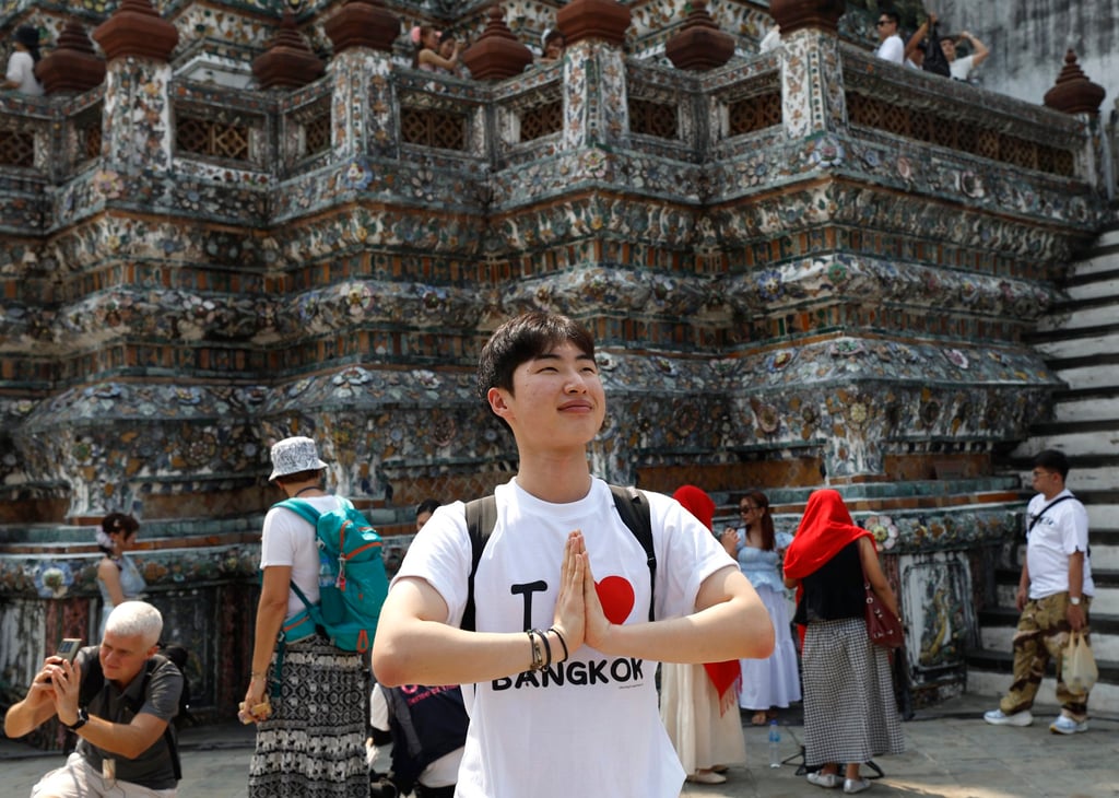 A tourist does the traditional Thai greeting during a visit to the Temple of Dawn (Wat Arun) in Bangkok in January. Thailand drew 32.9 million foreign visitors in 2025. Photo: EPA A tourist does the traditional Thai greeting during a visit to the Temple of Dawn (Wat Arun) in Bangkok in January. Thailand drew 32.9 million foreign visitors in 2025. Photo: EPA