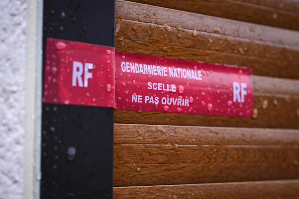 Official seals of French law enforcement taped across a door at a house where the bodies of two infants were discovered in a freezer. Photo: AFP