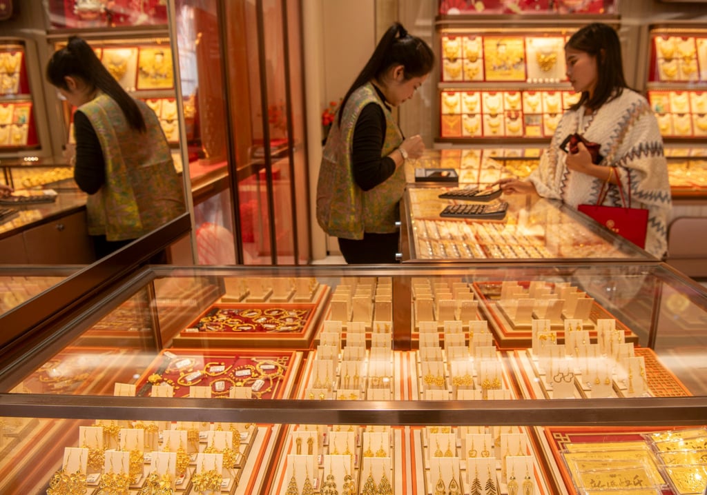 A customer selects gold accessories at a shop in China’s Hainan province on January 29. The price of the precious metal has soared amid global uncertainty. Photo: Xinhua A customer selects gold accessories at a shop in China’s Hainan province on January 29. The price of the precious metal has soared amid global uncertainty. Photo: Xinhua