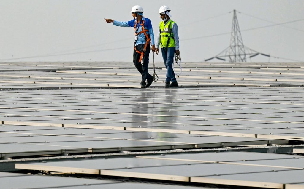Employees at SunSource Energy inspect solar panels installed at a food processing plant in November 2024. Photo: AFP