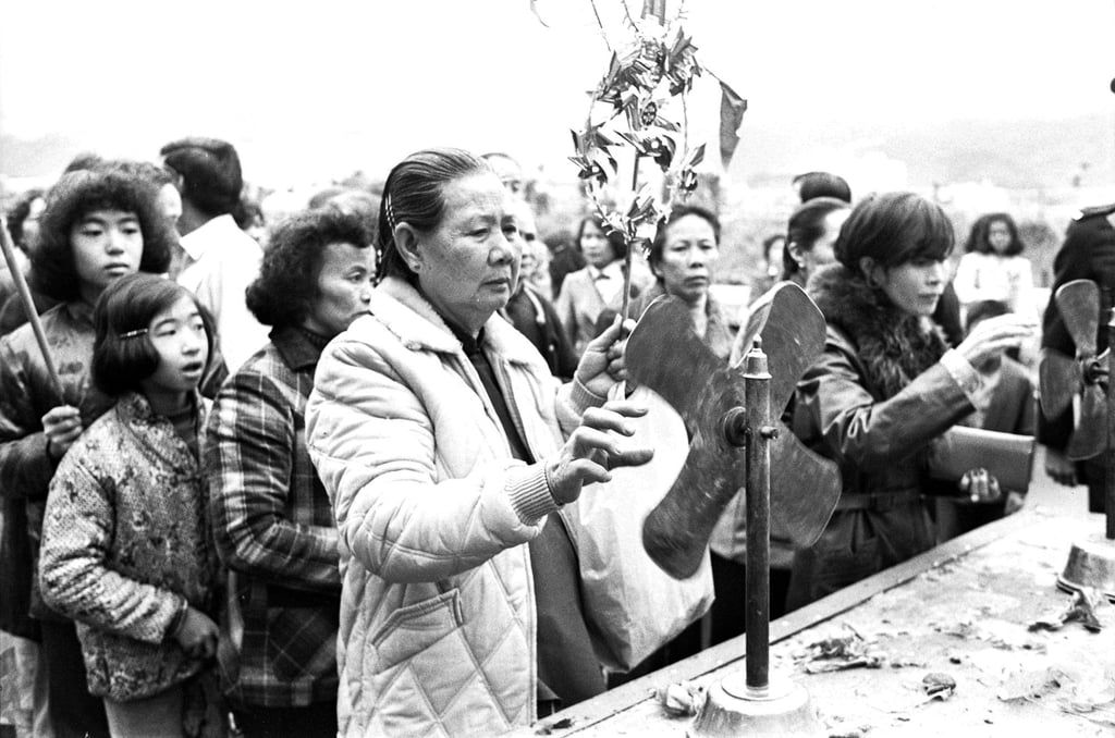 A woman spins the blades of a windmill – a traditional charm believed to turn bad luck into good fortune, increase prosperity and improve health – on the third day of the Lunar New Year at Che Kung Temple in 1979. Photo: SCMP Archives A woman spins the blades of a windmill – a traditional charm believed to turn bad luck into good fortune, increase prosperity and improve health – on the third day of the Lunar New Year at Che Kung Temple in 1979. Photo: SCMP Archives