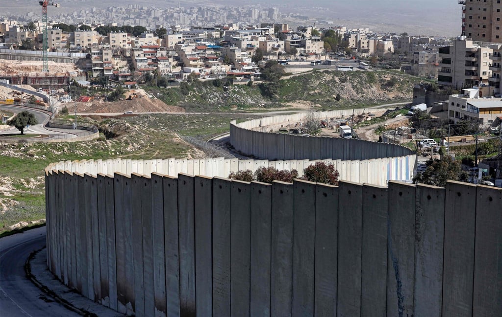 The Israeli settlement of Pisgat Zeev (left), built in a suburb of the mostly Arab East Jerusalem, is seen behind Israel’s separation barrier on Monday. Photo: AFP The Israeli settlement of Pisgat Zeev (left), built in a suburb of the mostly Arab East Jerusalem, is seen behind Israel’s separation barrier on Monday. Photo: AFP