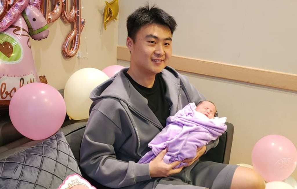 Mr Zhong holds his newborn daughter at Union Hospital. Photo: Handout