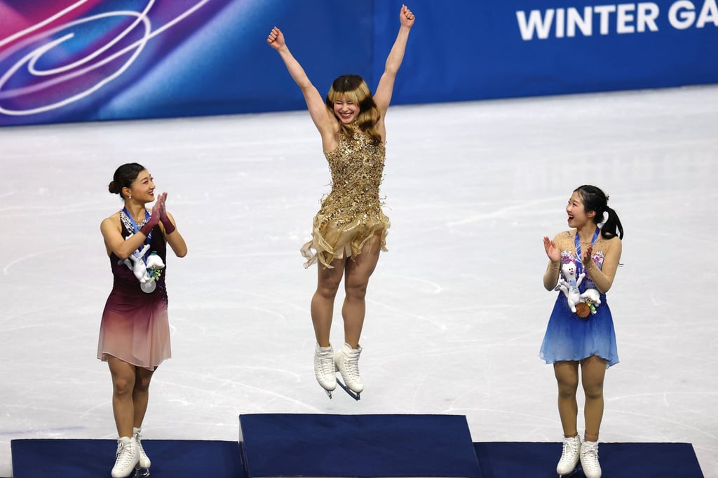 Gold medallist Alysa Liu of the United States celebrates on the podium after winning the women's single skating with silver medallist Kaori Sakamoto of Japan and bronze medallist Ami Nakai of Japan. Photo: Reuters