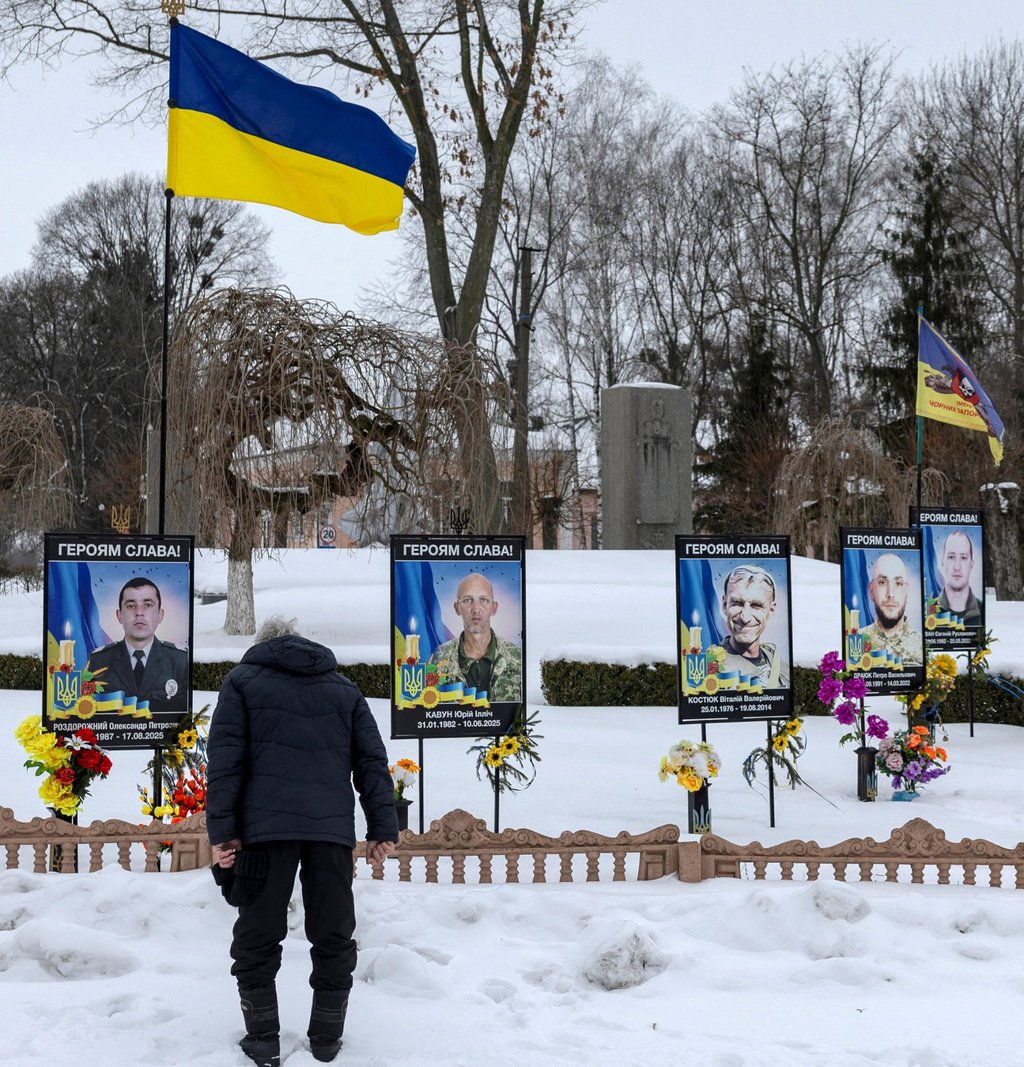 A man pays respects to his fallen relative at a memorial site for Ukrainian servicemen who died fighting the invading Russian army in Dzenzelivka on February 4. Photo: Reuters A man pays respects to his fallen relative at a memorial site for Ukrainian servicemen who died fighting the invading Russian army in Dzenzelivka on February 4. Photo: Reuters