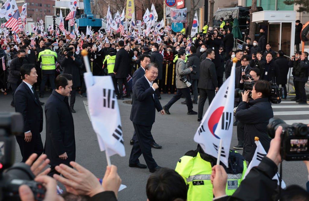 Former South Korean president Yoon Suk-yeol (centre) greets supporters upon his arrival at the presidential residence in Seoul, South Korea, on March 8, 2025. Photo: Yonhap / AP