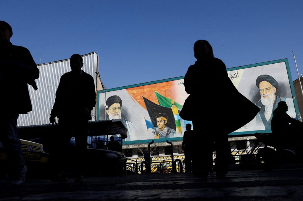 People walk near a mural featuring images of Iran’s Supreme Leader Ayatollah Ali Khamenei and leader of Iran’s 1979 Islamic Revolution Ayatollah Ruhollah Khomeini in Tehran on Tuesday. Photo: WANA via Reuters People walk near a mural featuring images of Iran’s Supreme Leader Ayatollah Ali Khamenei and leader of Iran’s 1979 Islamic Revolution Ayatollah Ruhollah Khomeini in Tehran on Tuesday. Photo: WANA via Reuters