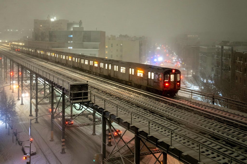 A subway train travels on snow-covered tracks. Photo: AFP A subway train travels on snow-covered tracks. Photo: AFP