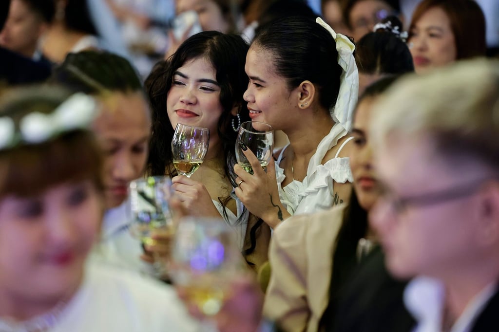 A couple hold their glasses after a toast during a LGBTQ commitment ceremony to mark Valentine’s Day in Manila on February 14. Photo: EPA