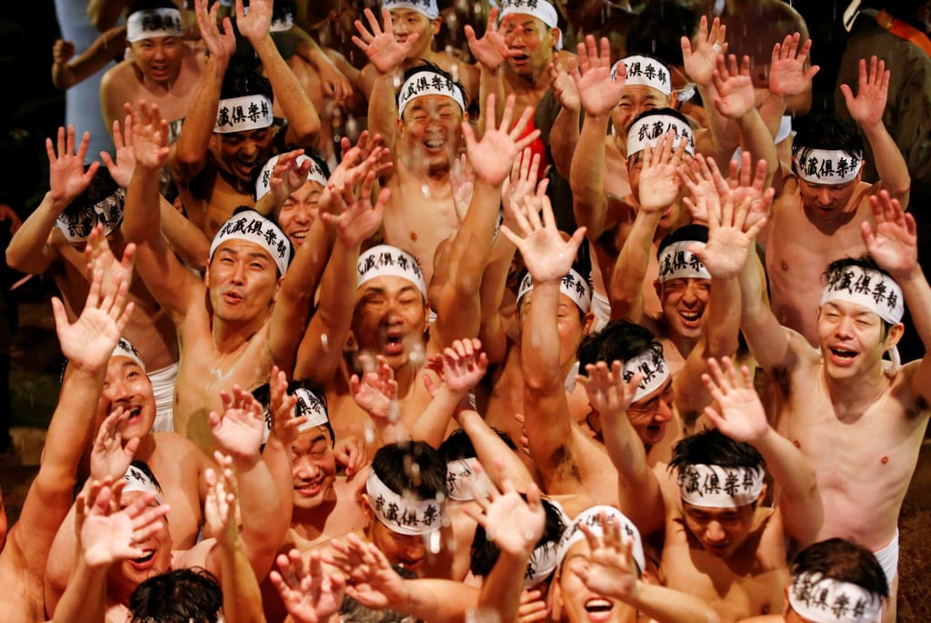 Men in loincloths are doused with water before competing for a sacred wooden stick, or shingi, at the “naked festival” at Saidaiji Temple in 2020. Photo: Reuters Men in loincloths are doused with water before competing for a sacred wooden stick, or shingi, at the “naked festival” at Saidaiji Temple in 2020. Photo: Reuters