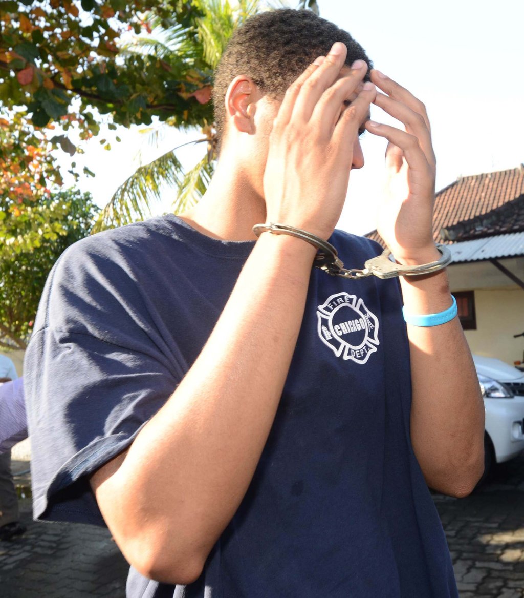 Tommy Schaffer is escorted by police after his arrest in Bali on August 13, 2014. Photo: AFP