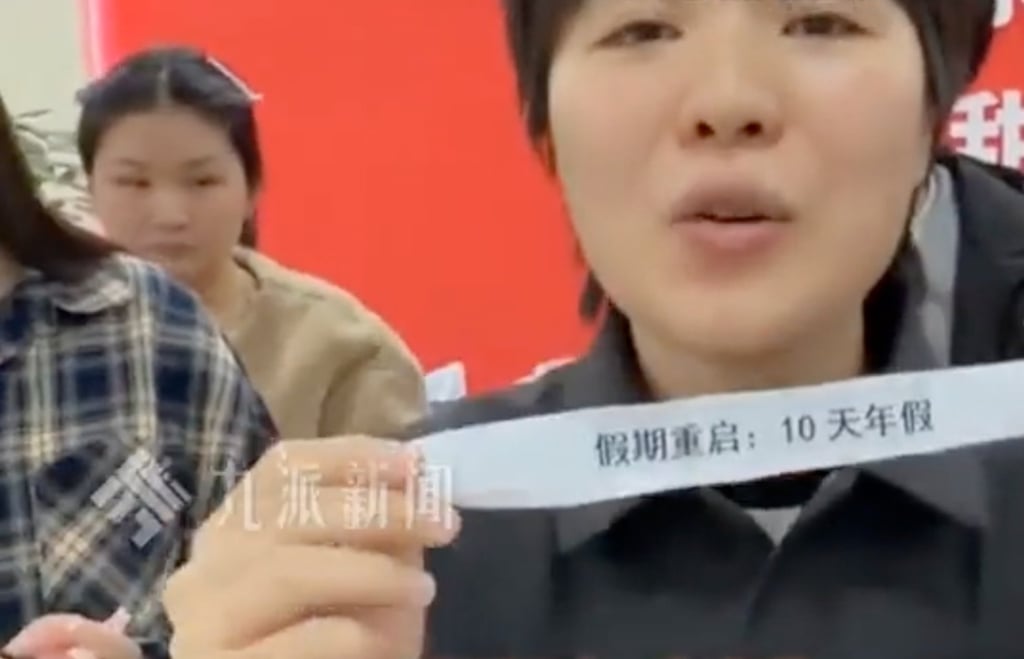 The lucky employee, surnamed Tao, shows off the tag denoting her prize. Photo: Sohu The lucky employee, surnamed Tao, shows off the tag denoting her prize. Photo: Sohu