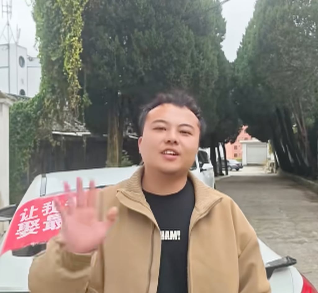 Tan, who runs his own business, waves at the camera during a stop-off along the way. Photo: Douyin
