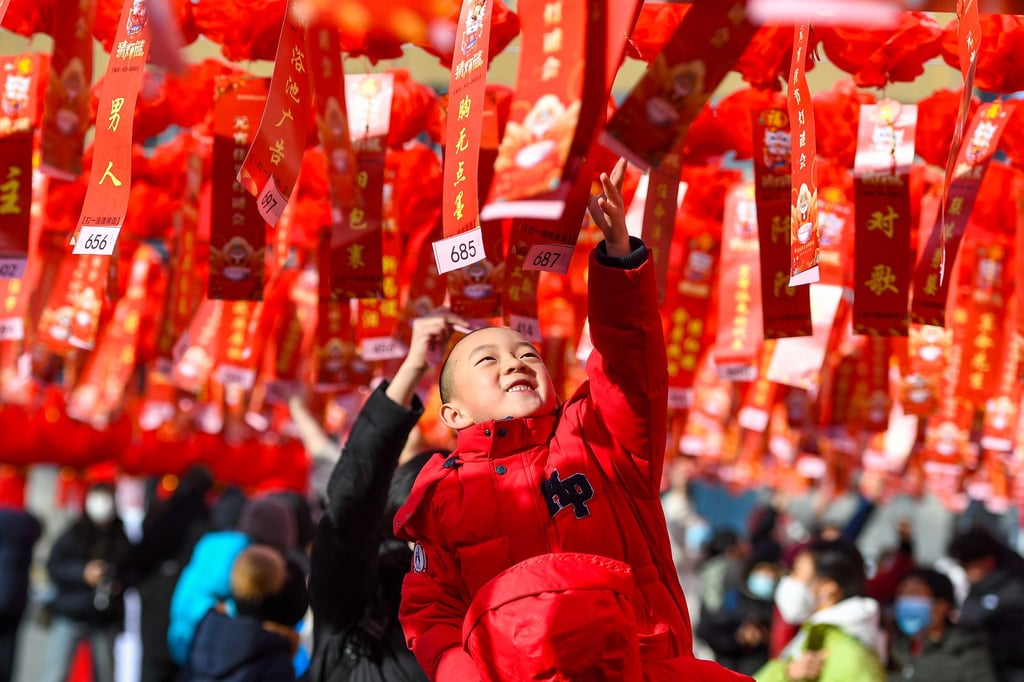 A child takes part in a lantern riddle game during an event celebrating the Lantern Festival in Changchun, in China’s Jilin province. Photo: Xinhua/Zhang Nan
