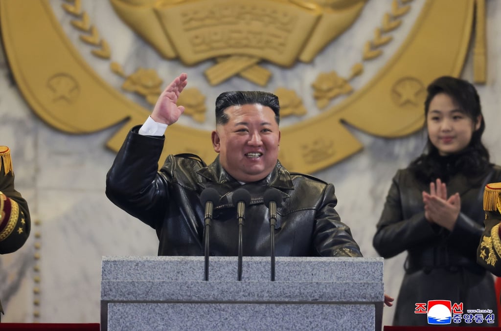 North Korean leader Kim Jong-un gestures while his daughter, believed to be named Kim Ju-ae, looks on during a military parade in Pyongyang on Wednesday. Photo: EPA/KCNA