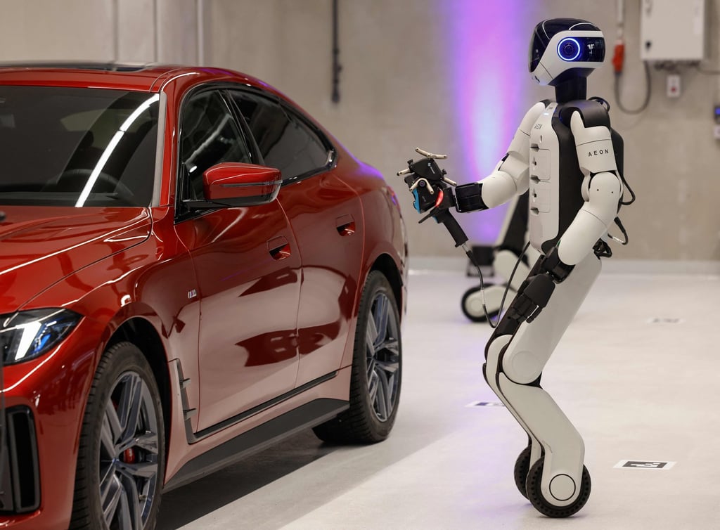Aeon, a humanoid robotic created by the company Hexagon, works on a car with a laser scanner in Munich, Germany, on Friday. Photo: AFP Aeon, a humanoid robotic created by the company Hexagon, works on a car with a laser scanner in Munich, Germany, on Friday. Photo: AFP