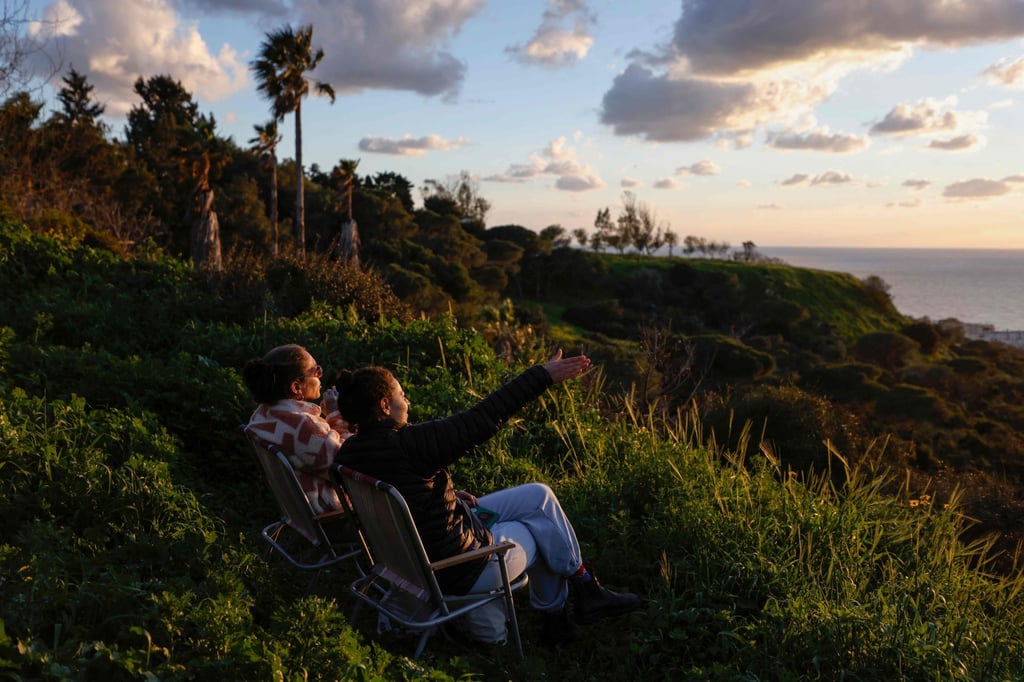 People watch the Mediterranean Sea from the city of Haifa on Friday as they wait for the USS Gerald R. Ford aircraft carrier to arrive off the coast of Israel. Photo: AFP