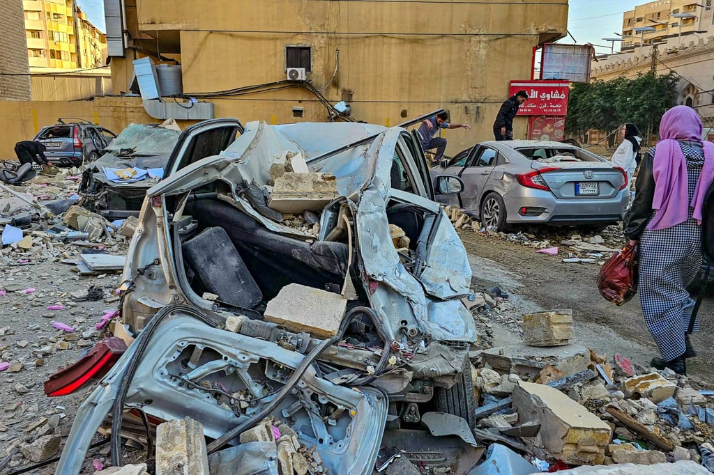 People check the wreckage after an Israeli air strike in the southern Beirut suburb of Haret Hreik on Monday. Photo: AFP