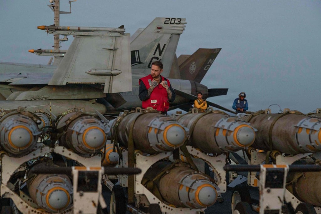US sailors on the flight deck of the aircraft carrier USS Abraham Lincoln in the Arabian Sea on Friday. Photo: AFP / US CENTCOM / US Navy / Handout