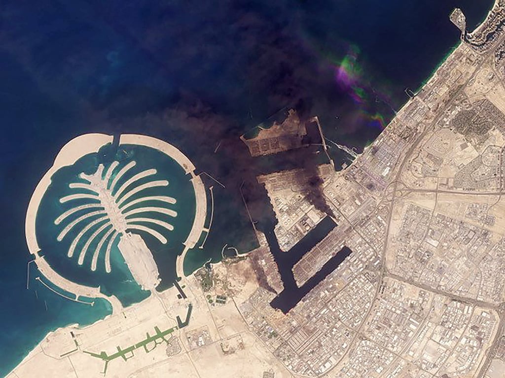 A satellite image shows plumes of smoke billowing over Dubai on Monday after missile strikes. Photo: Planet Labs PBC/AFP