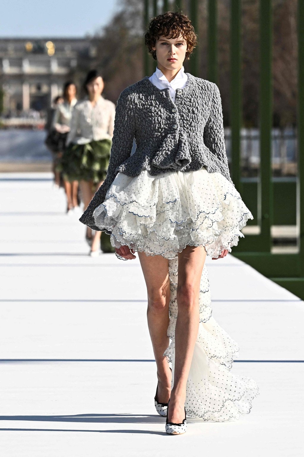 The Dior show opened with a shrunken cardigan paired with a tiered skirt. Photo: AFP