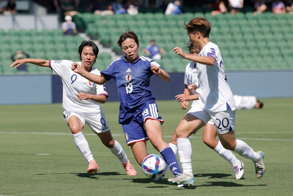 Japan midfielder Momoko Tanikawa is surrounded by Taiwanese players. Photo: EPA