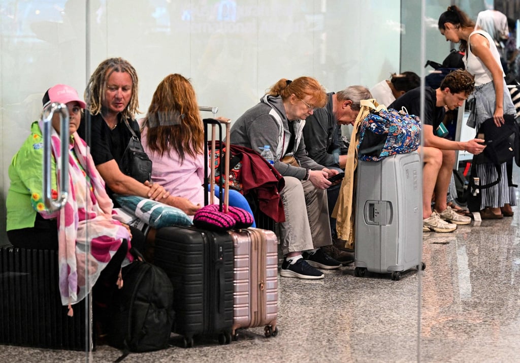 Stranded passengers hang around Bali’s Ngurah Rai International Airport on Monday. Photo: AFP Stranded passengers hang around Bali’s Ngurah Rai International Airport on Monday. Photo: AFP