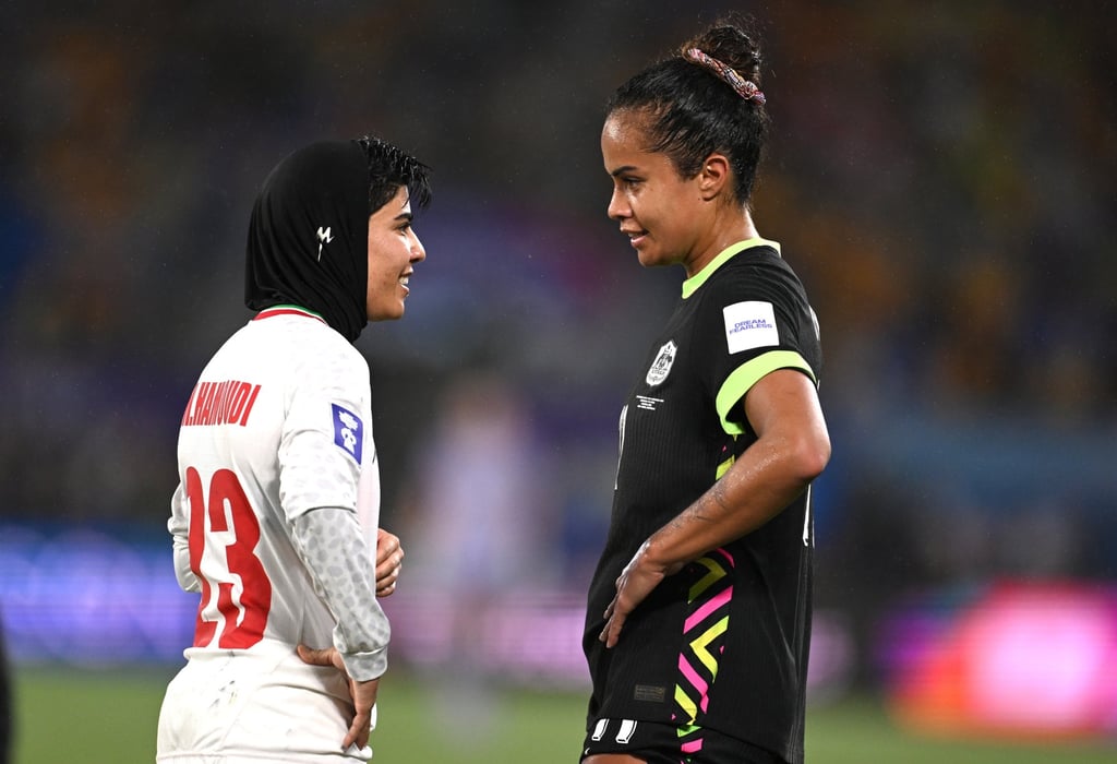 Iran’s Mona Hamoudi (left) chats with Mary Fowler of Australia during a stoppage. Photo: EPA
