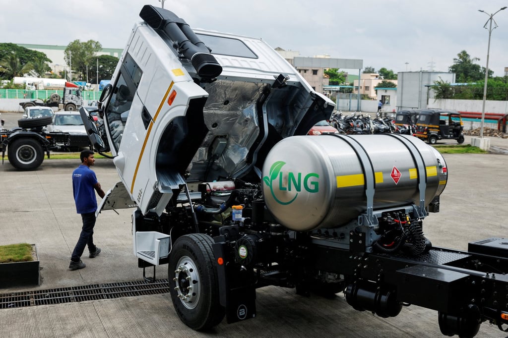 A man opens the bonnet of a liquefied natural gas truck to check the engine at the manufacturing facility in Pune, India. The halt in Qatar’s LNG output has sent buyers across Asia searching for replacement cargoes. Photo: Reuters
