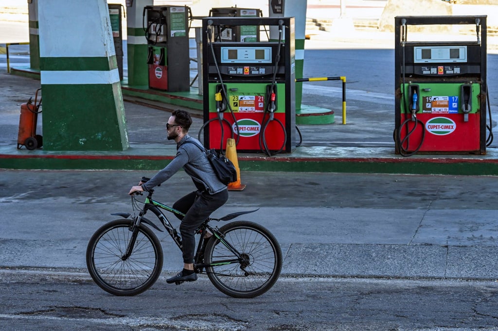 A man rides his bicycle past an empty petrol station in Havana in February. Photo: AFP/TNS