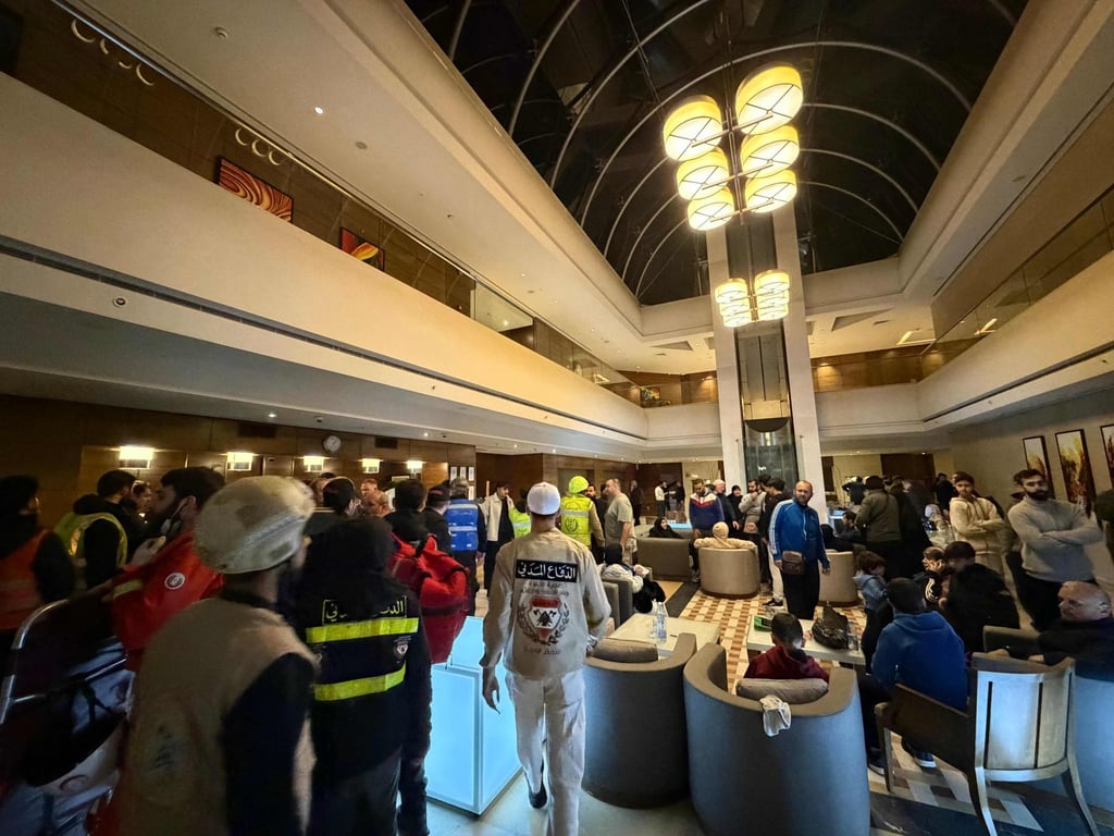 First aid workers are seen inside the lobby of the Ramada hotel where a room was targeted by an Israeli strike, in Beirut, Lebanon, on Sunday. Photo: AFP