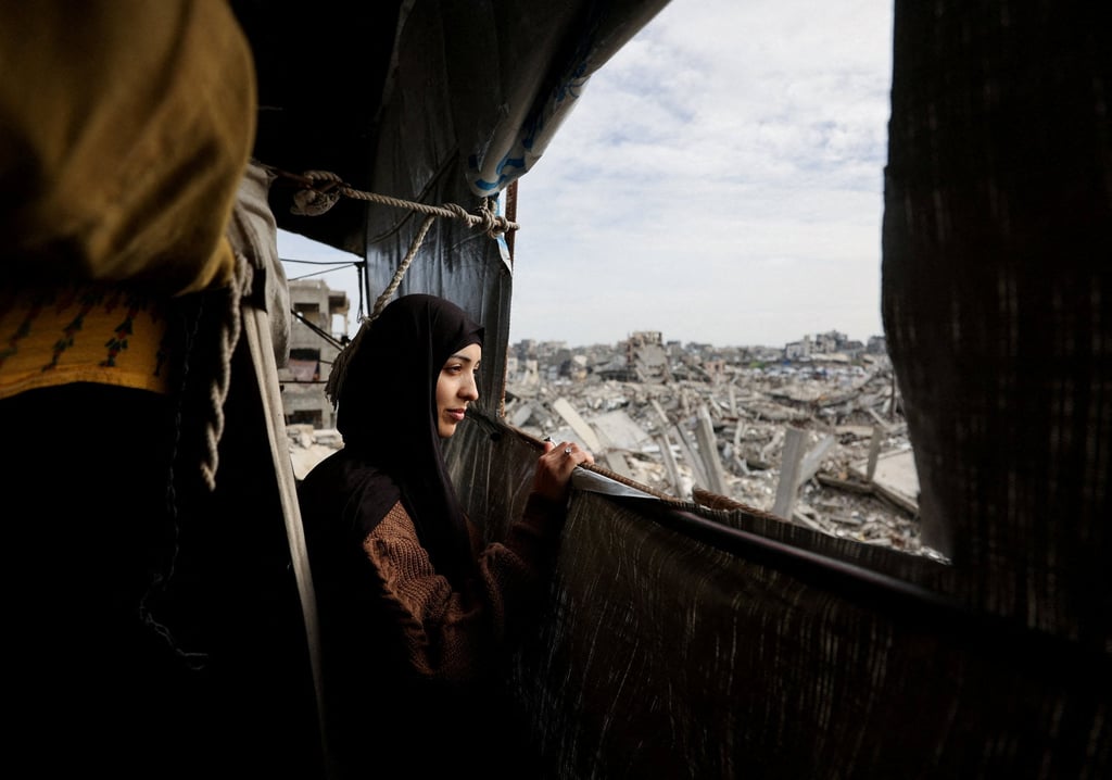 A Palestinian mother sits and looks out from a window of a tent set up inside her war-damaged home in the Gaza Strip on February 6. Photo: Reuters