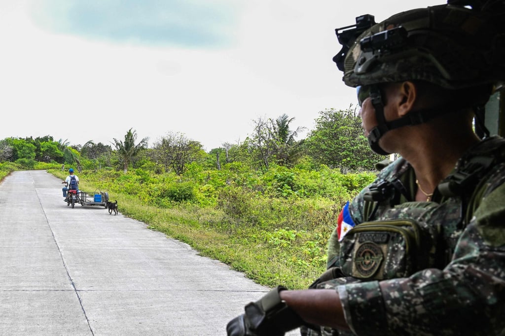 A Filipino soldier watches a resident pass by on Thitu Island in the South China Sea last month. The Philippines has been pivoting away from internal security towards territorial defence. Photo: AFP A Filipino soldier watches a resident pass by on Thitu Island in the South China Sea last month. The Philippines has been pivoting away from internal security towards territorial defence. Photo: AFP