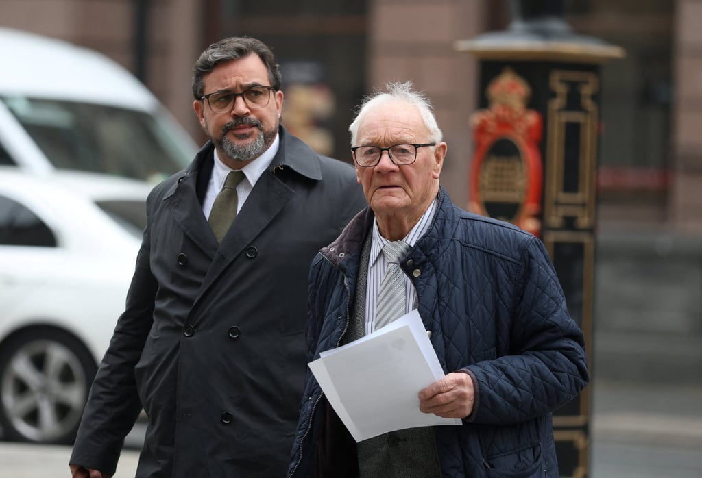 Barry Laycock (right), a survivor of the 1996 Manchester IRA bombing, arrives at court in London on Monday with his lawyer ahead of a trial which aims to hold former Sinn Fein president Gerry Adams liable for IRA bombings. Photo: Reuters