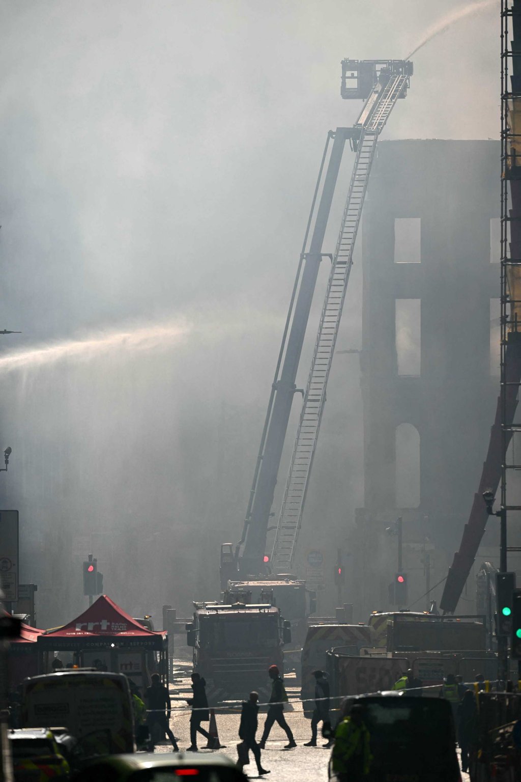 Firefighters work at the site of a large fire next to Glasgow’s main railway station on Sunday. Photo: AFP