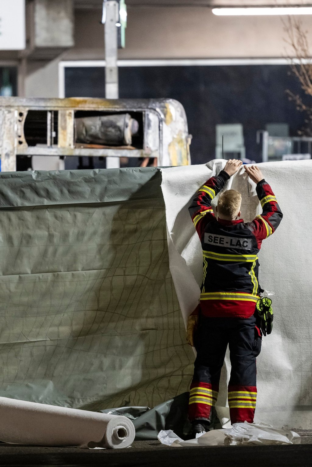 Firefighters cordon off the area in front of a bus after it caught fire in Kerzers, Switzerland, on Tuesday. Photo: EPA