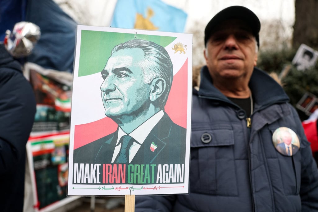 A man holds a placard depicting Reza Pahlavi as demonstrators gather in support of military action against the Iranian regime, outside the Iranian embassy in London, in February 2026. Photo: Reuters